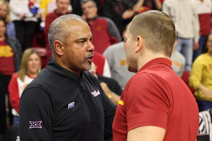 Tang, left, said he told Otzelberger about Kansas State’s accusations during this exchange.